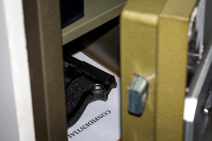 Open gun safe door with pistol inside