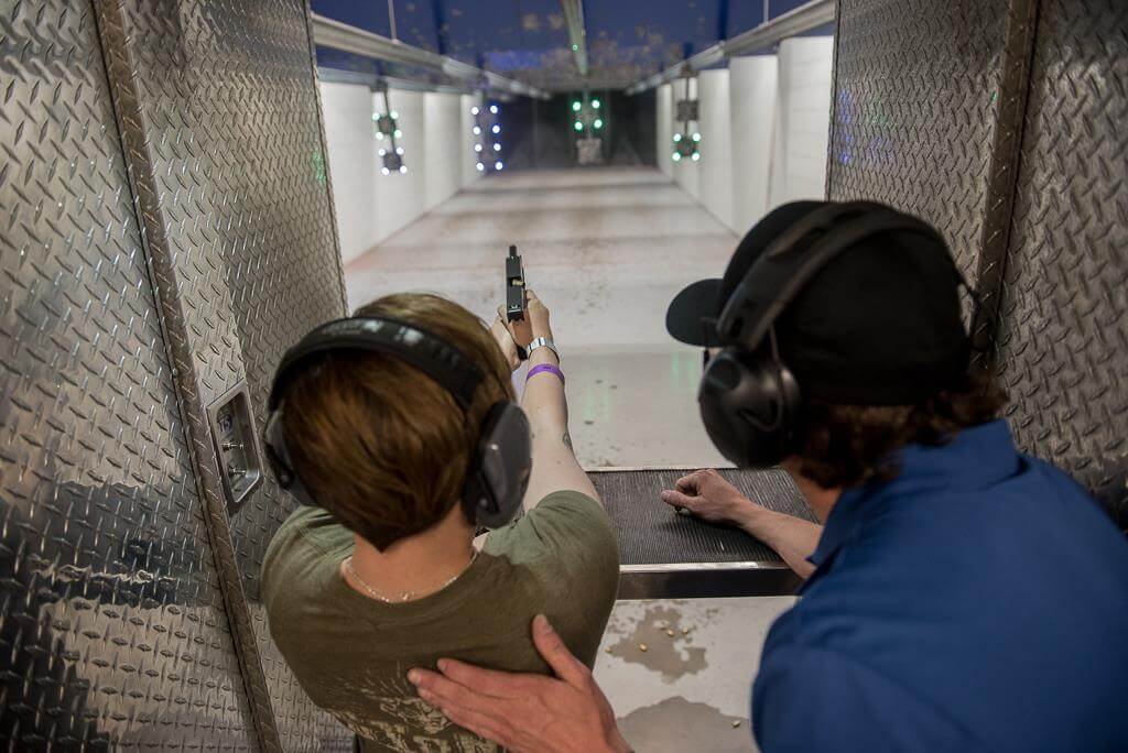 gun instructor showing someone how to shoot