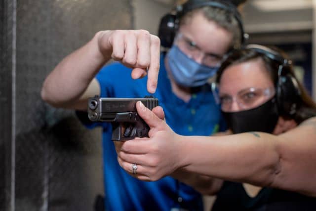 An instructor teaching their client how to shoot at The Range 702.