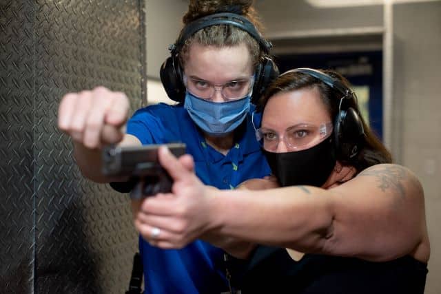 Instructor helping woman