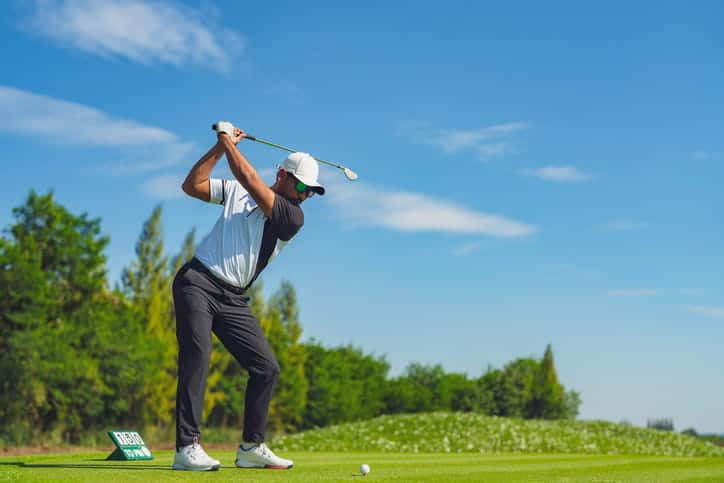 A man playing golf as a thing to do for a bachelor party.