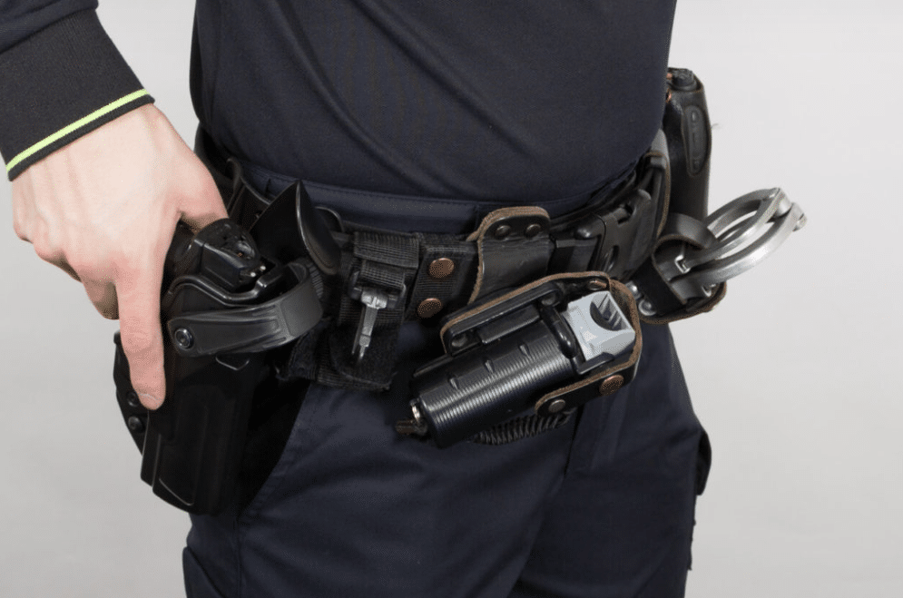 Armed security guard with his hand on his handgun in holster