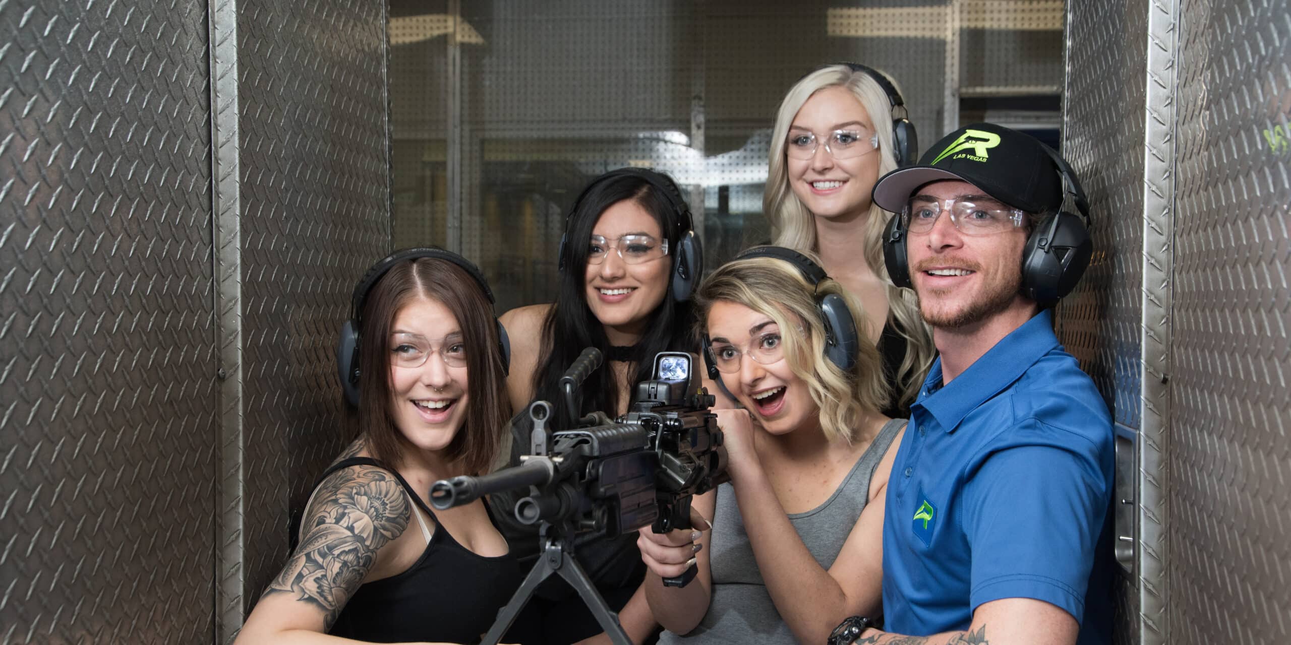 An instructor teaching 4 women on shooting a gun.