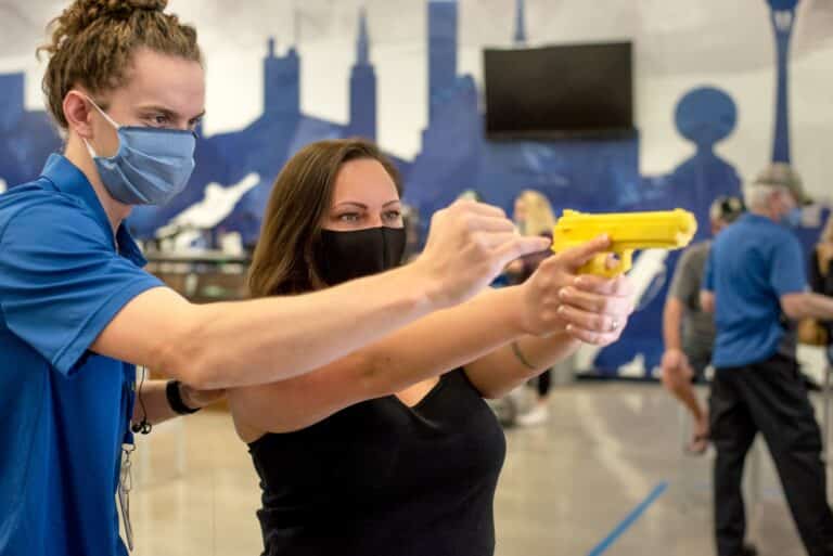 A female learning how to shoot at The Range 702.