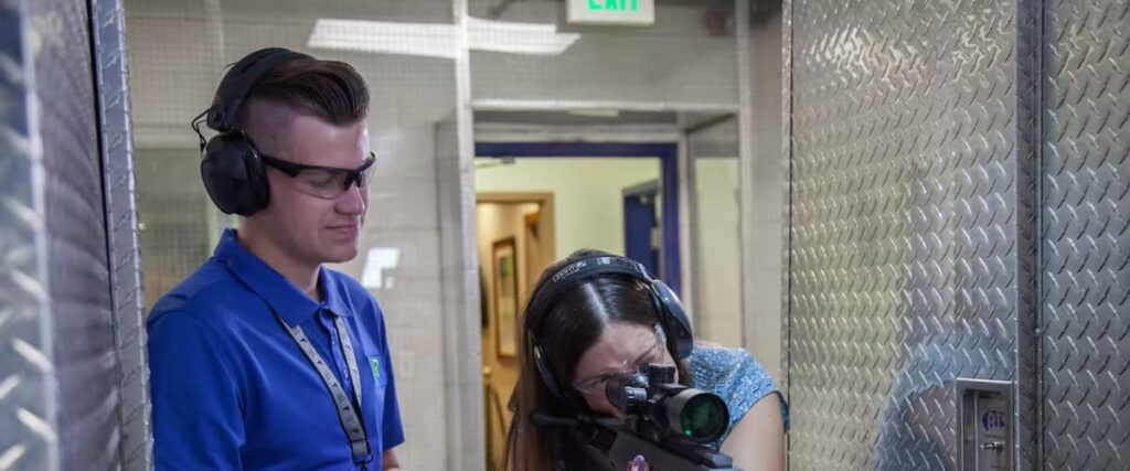 A female learning how to shoot at The Range 702.