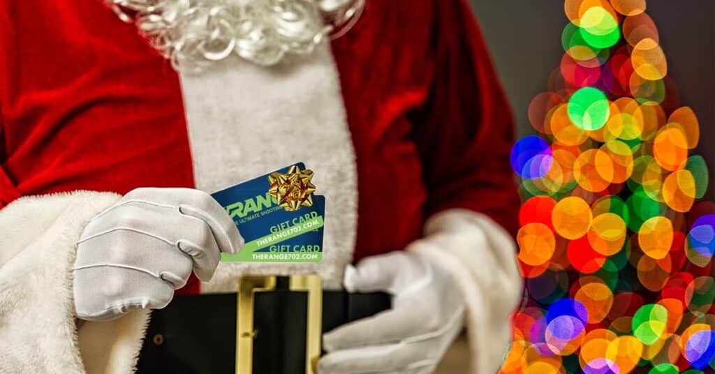 Santa holding The Range 702 gift card.