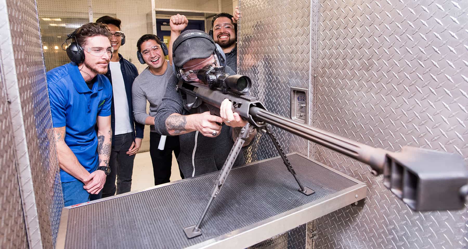 An instructor with 4 men shooting a gun at The Range 702.