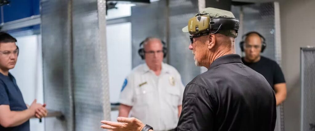 Three men are listening to their instructor at The Range 702.