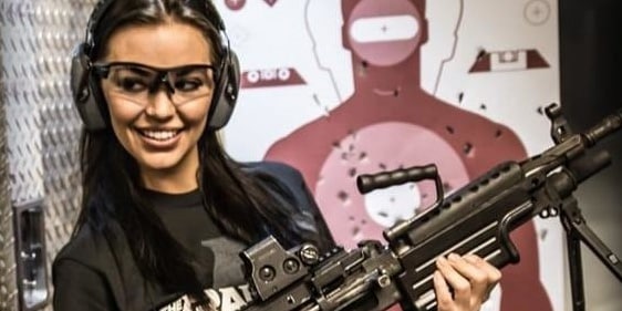 Woman holding a gun for the Extreme Experience at The Range 702