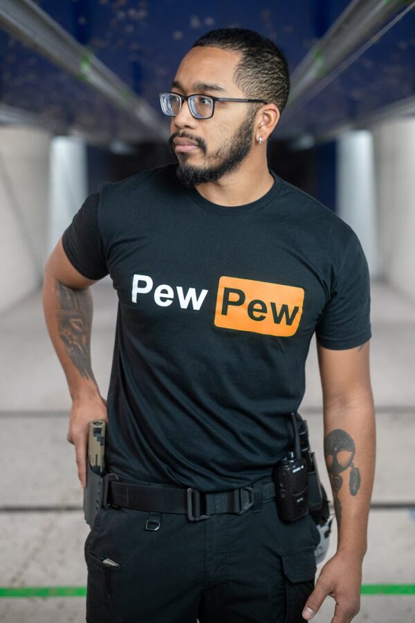A man wearing a shirt that says "Pew Pew."