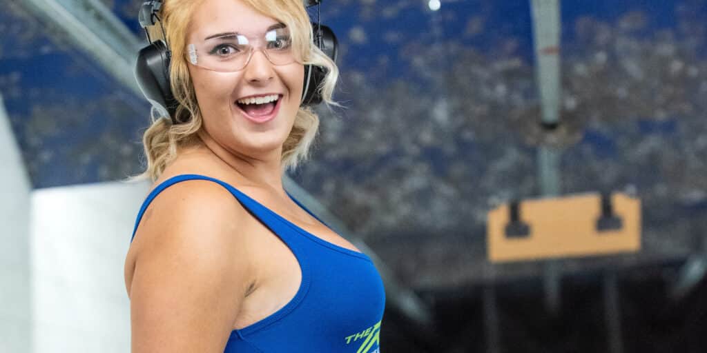 woman with a smile on her face at the shooting range