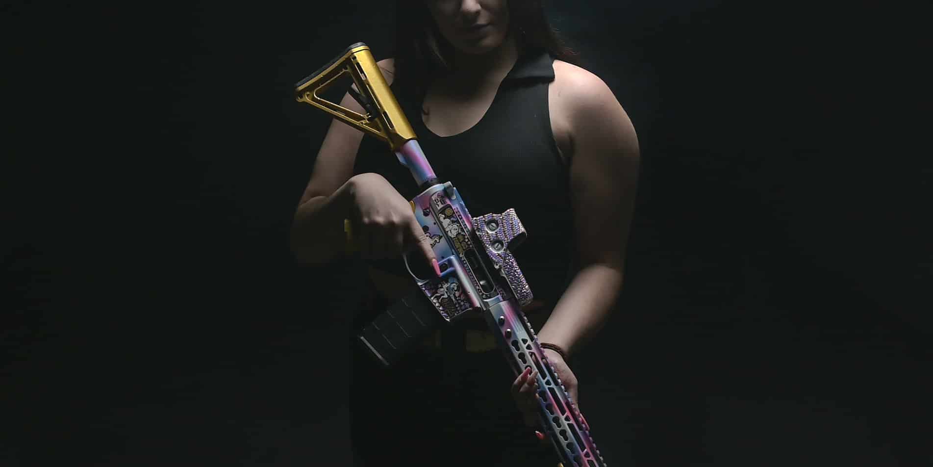 lady holding unicorn machine gun