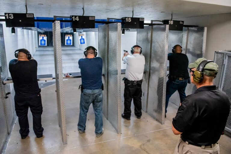 4 men shooting handguns at a shooting range in las vegas
