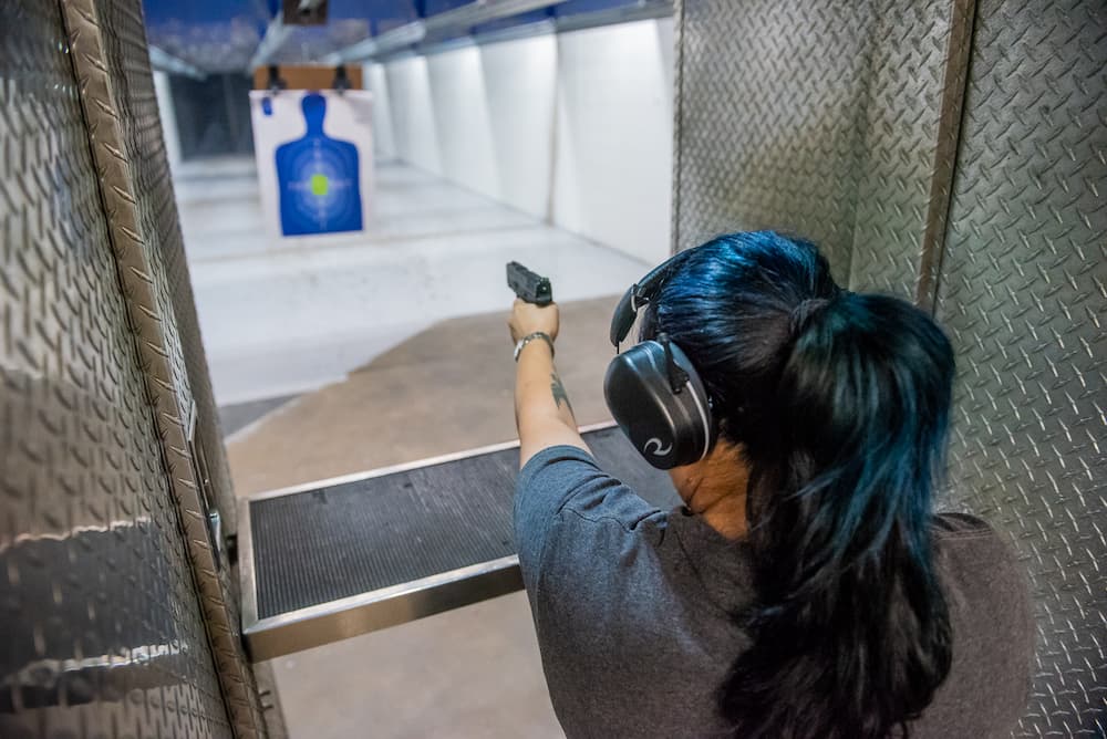 A woman shooting at a target at The Range 702.