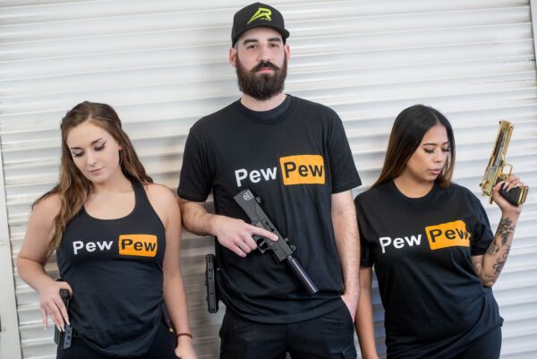 A man and two women with "Pew Pew" shirts.