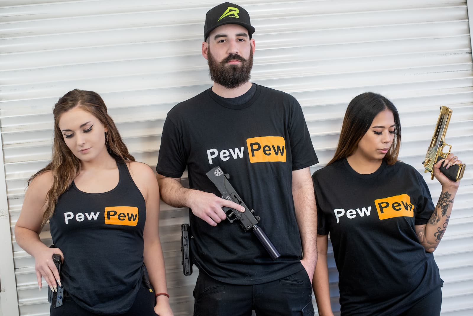 A Man And Two Women With &Quot;Pew Pew&Quot; Shirts.