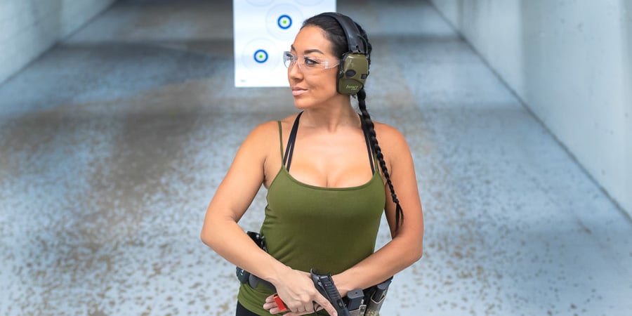 A lady standing in front of a shooting target at The Range 702.