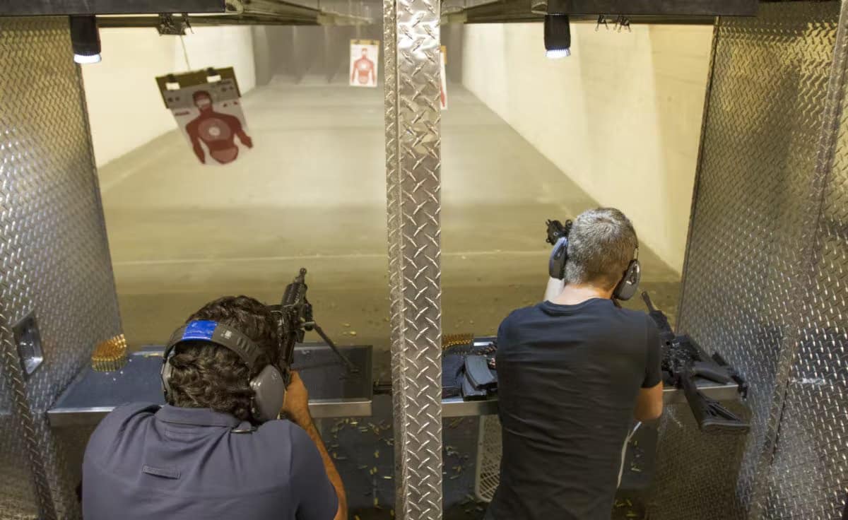 2 people shooting guns at the range 702