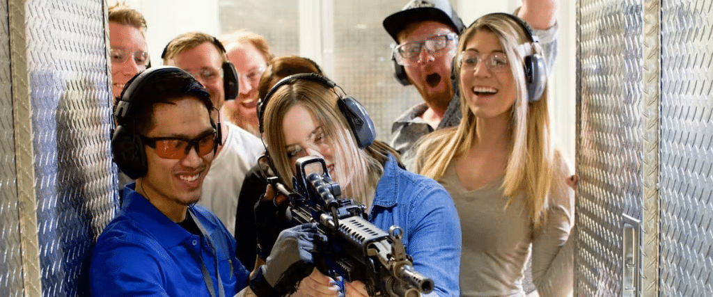 A crowd watches a woman shoot at The Range 702.