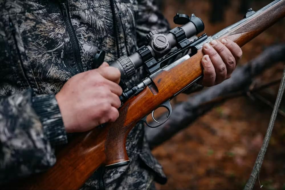 person holding a hunting rifle