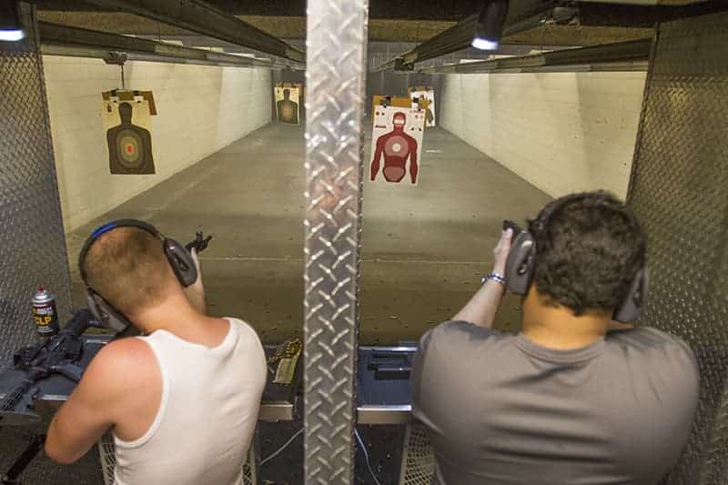 two guys shooting machine guns