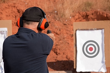 man shooting a handgun at a target in las vegas
