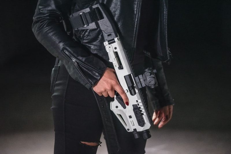 lady holding glock roni gun