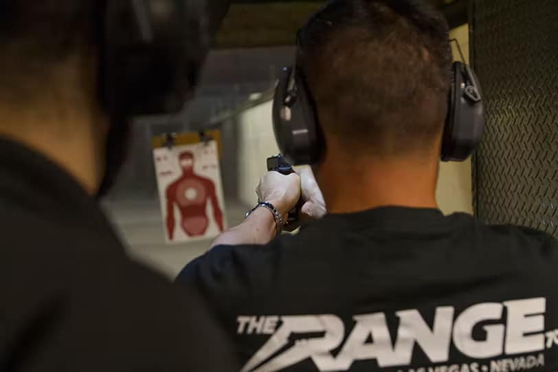 person shooting gun in the range 702 gun range