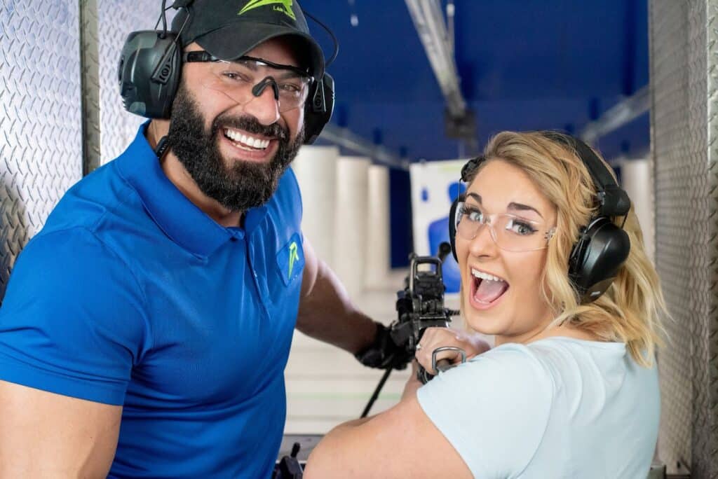 trainer and lady shooting a machine gun at the range 702 in las vegas