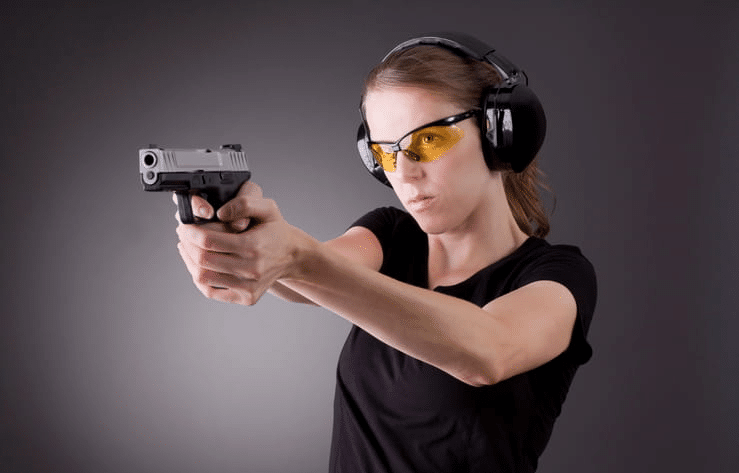 a woman shooting a gun