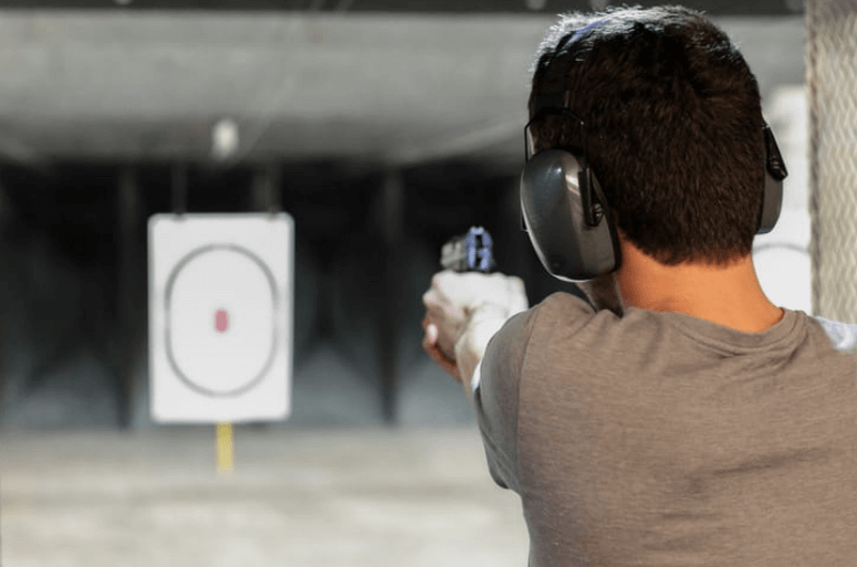 man practicing shooting at a shooting range