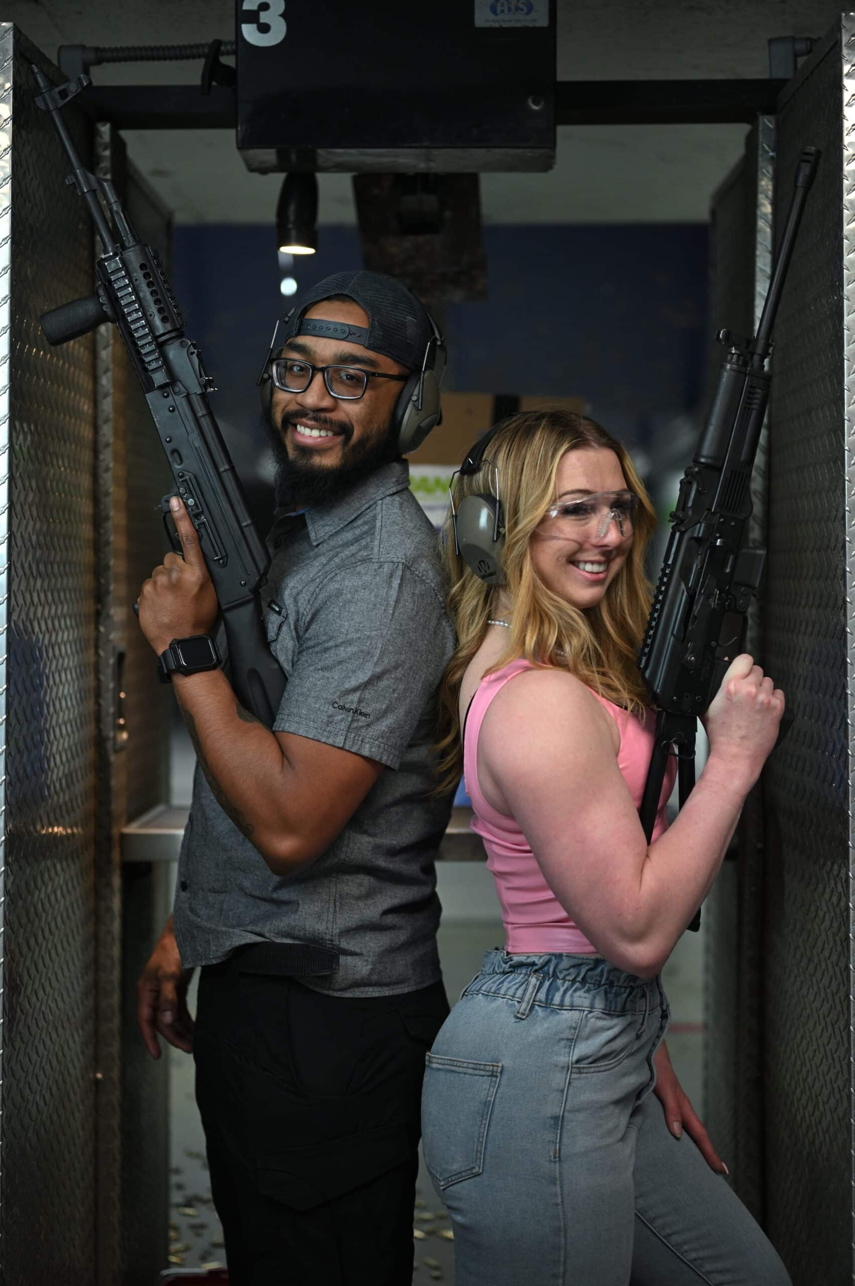 man and woman holding machine guns at a shooting range in las vegas for a birthday party